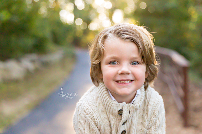 Young boy smiling at camera Longview Farm Park | St. Louis Family Photographer