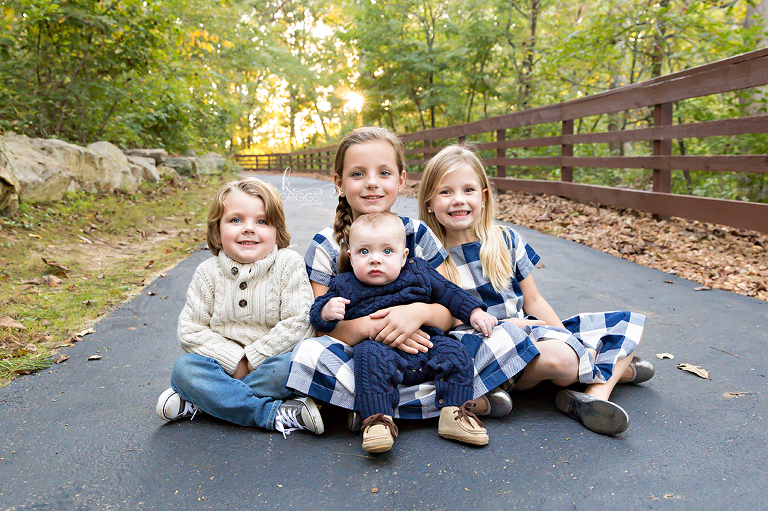 4 siblings sitting on path Longview Farm Park | St. Louis Photographer