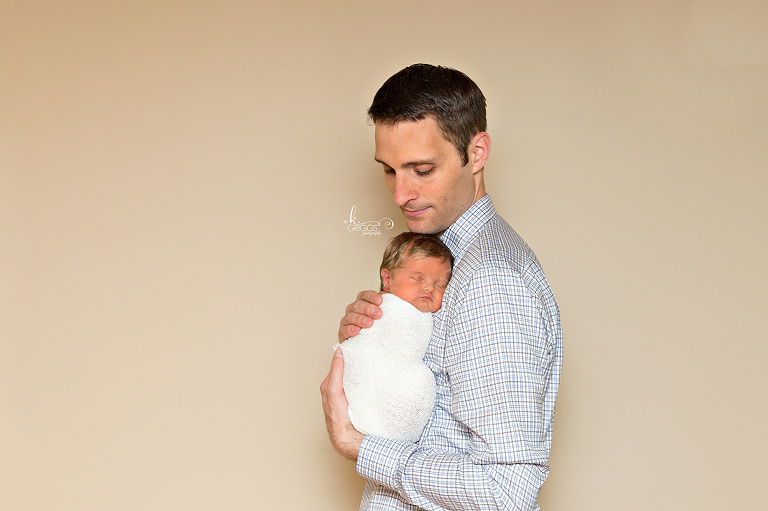 Daddy holding newborn daughter. | St. Louis Newborn Photorapher