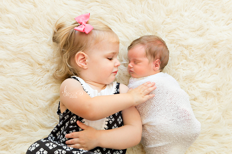 Big sister touching brand new baby sister | St Louis Newborn Photographer