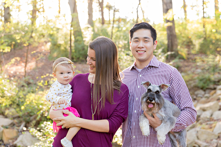 Family of 3 with a dog smiling - Longview Farm Park | St. Louis Photographer
