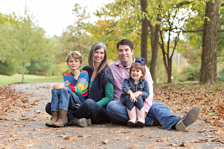 Family of 4 sitting on path in park | St. Louis Photographer