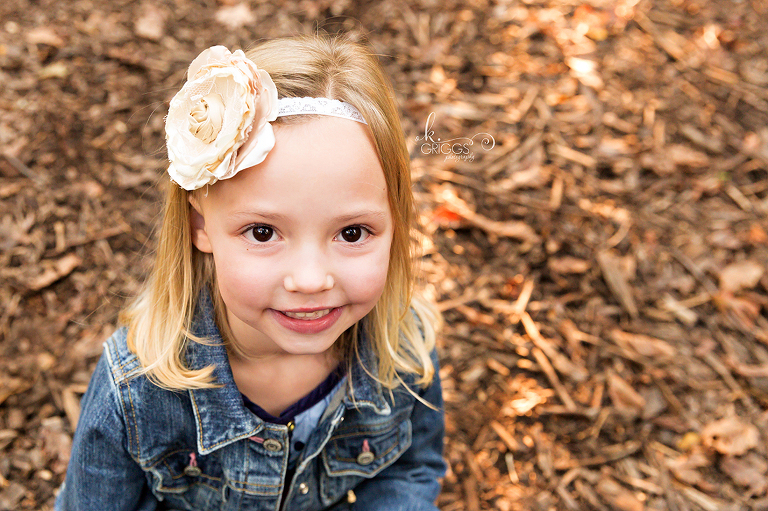 Little girl sitting on ground Longview Farm Park | St. Louis Children's Photographer