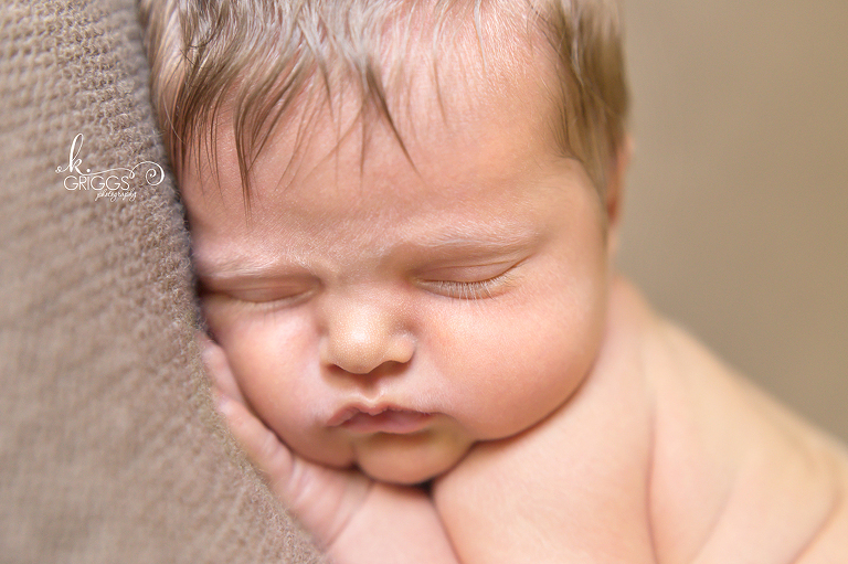Newborn baby sleeping on brown blanket | St Louis Photographer