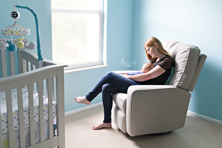 mom and newborn boy in nursery