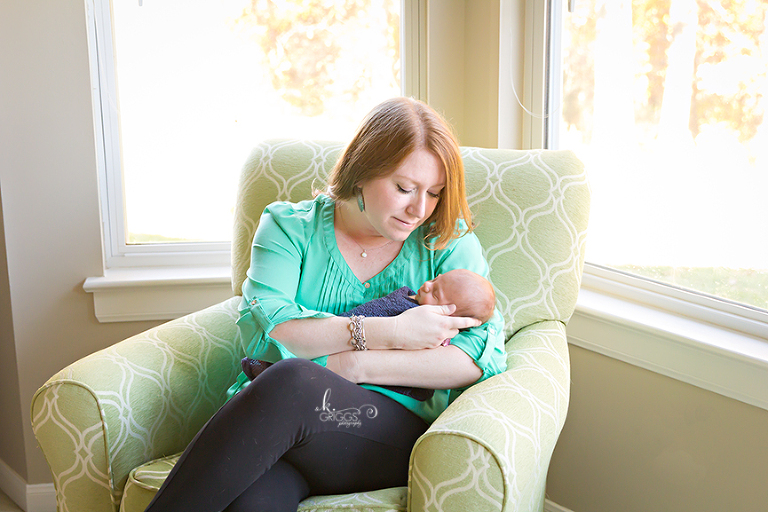 mom and newborn daughter in chair