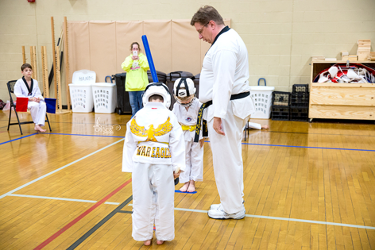 two boys bowing before sword fighting | st. louis children's photographer