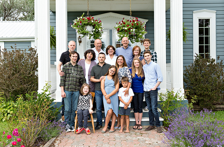 Whole extended family standing on steps of house. | St. Louis Portraits