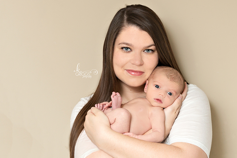 Mom holding baby in her arms | St. Louis Newborn Photographer