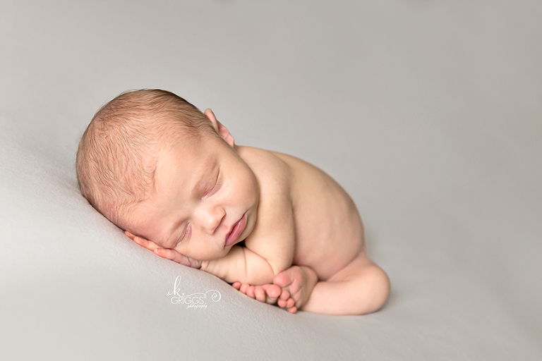 Newborn baby girl on gray blanket | St. Louis Photographer