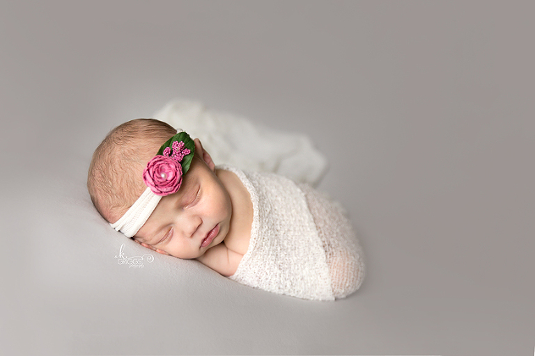 Baby girl wrapped in white wrap. | St. Louis Newborn Photos