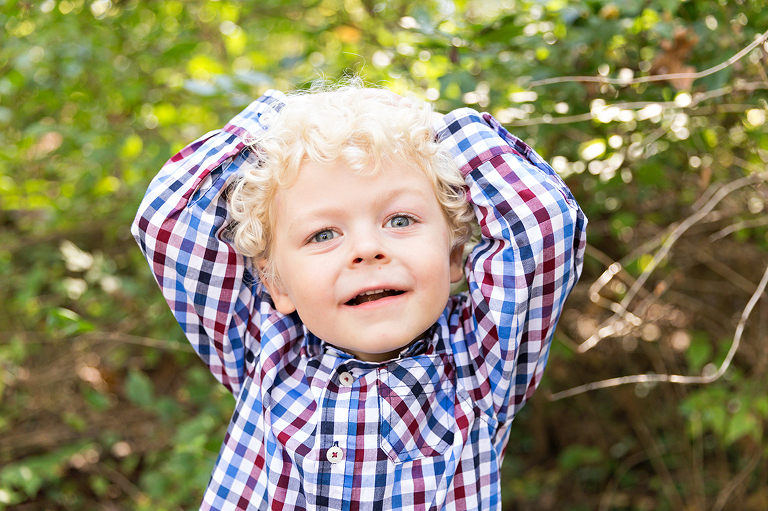 Young boy looking at camera with hand on head - Longview Farm Park | St. Louis Children's Photographer