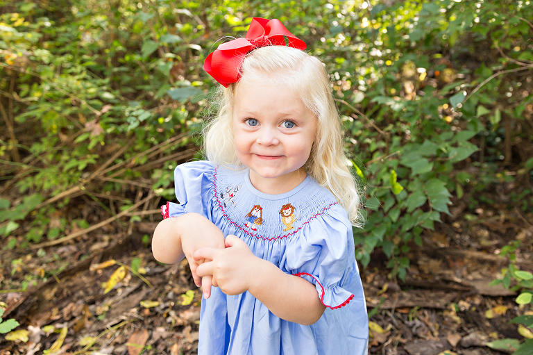 Young girl looking at camera smiling - Longview Farm Park | St. Louis Family Photos
