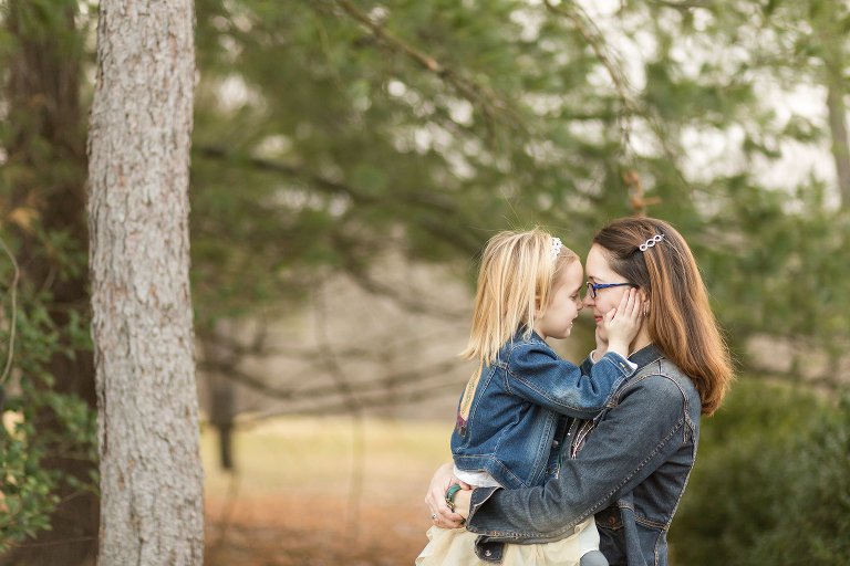 Mom holding daughter while they are looking at each other | St. Louis Family Photographer
