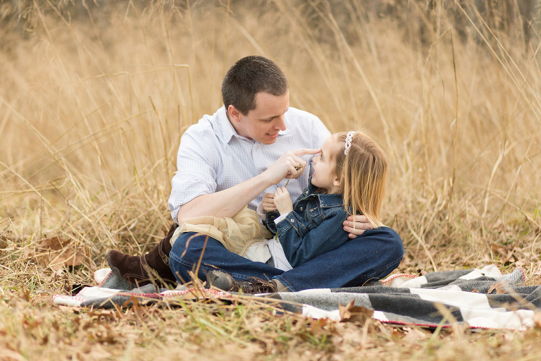 Father looking at young daughter and telling her a story | Kirkwood Kid's Photography