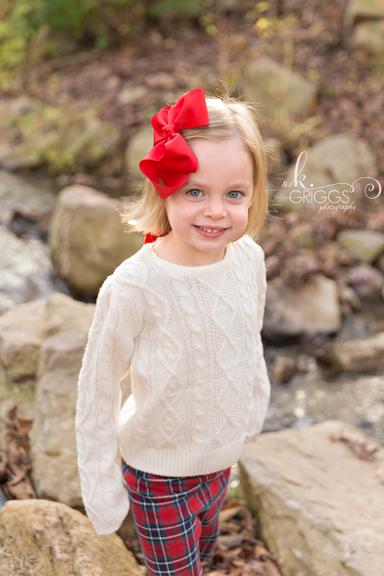 Young girl standing near creek smiling | St. Louis Kids Photographer