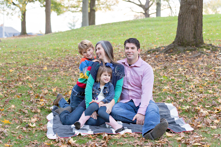 Family of 4 sitting on grass in park | Kirkwood Photographer