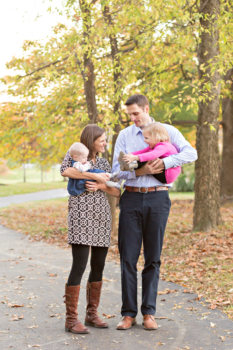 Mom and Dad holding toddler girls | St. Louis Family Photography