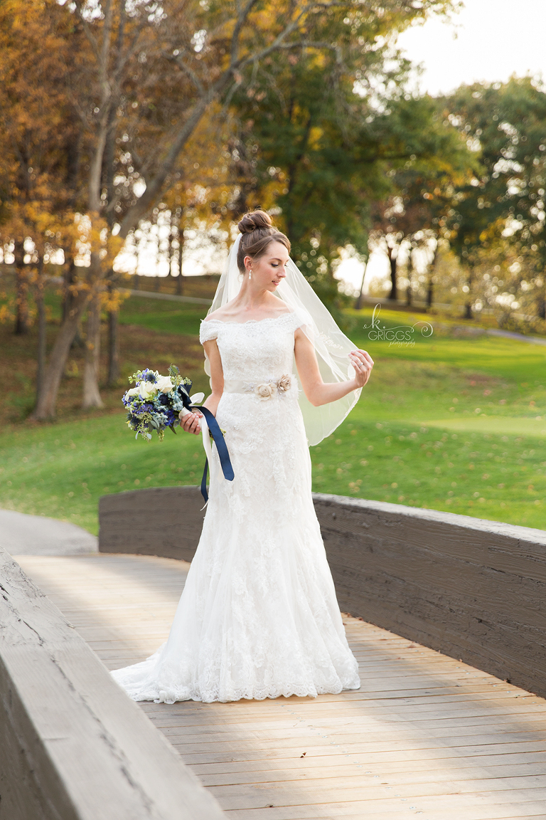 bride holding her veil and looking down | St. Louis Portraits