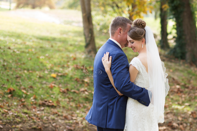 Groom whispering in bride's ear | St. Louis Photographer