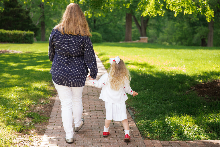 Mother and daughter walking down path | St. Louis Photographer