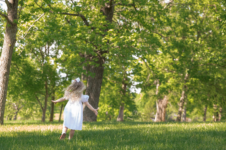 Little girl running and twirling in field | St. Louis Kids Portraits