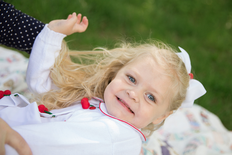 Little girl laying in her mother's lap | St. Louis Portraits