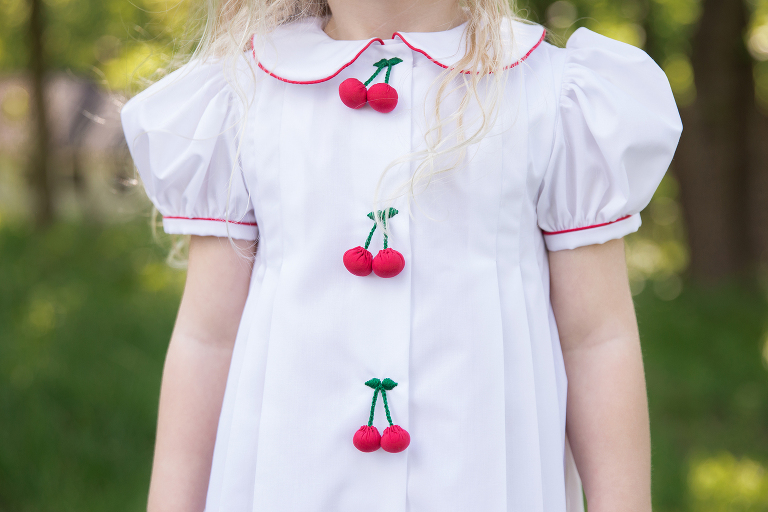Little girl's special dress with cherries | St. Louis Family Photographer