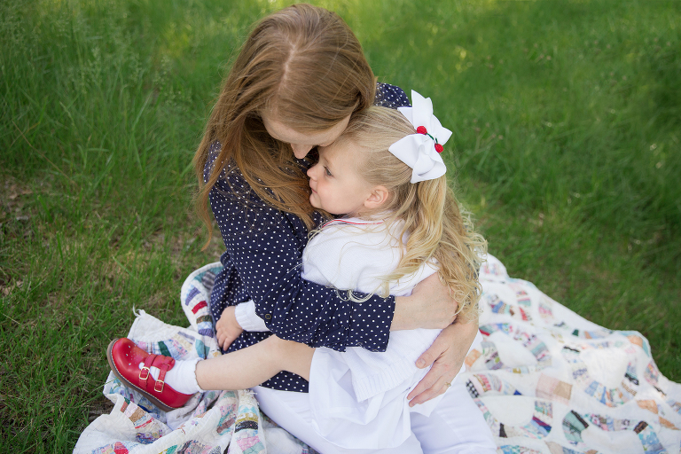 little girl sitting on her momma's lap | St. Louis Children's Photographer