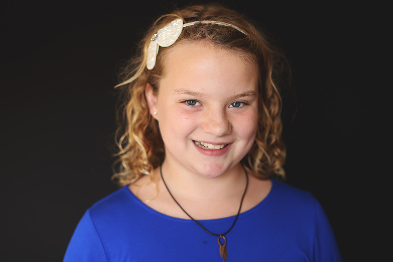 Tween girl smiling at camera | St. Louis School Pictures