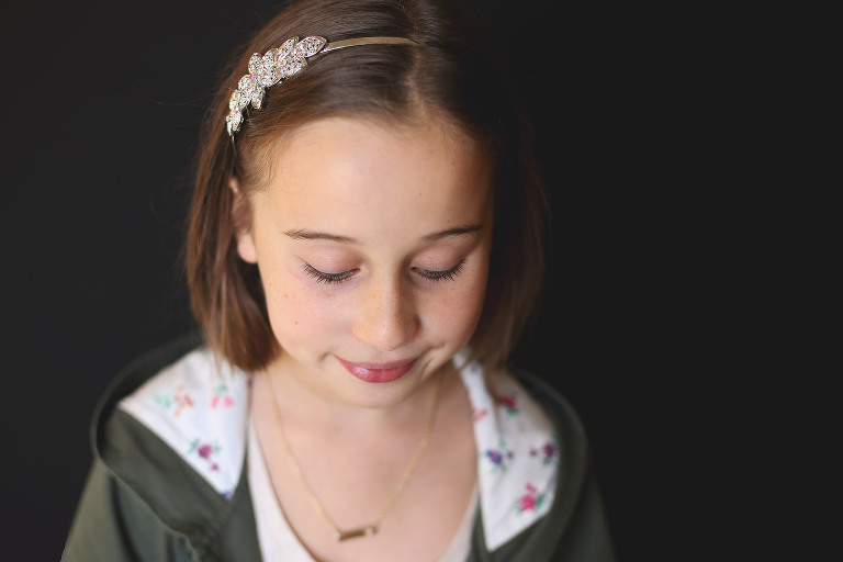 Young girl with headband looking down | St. Louis School Photographer