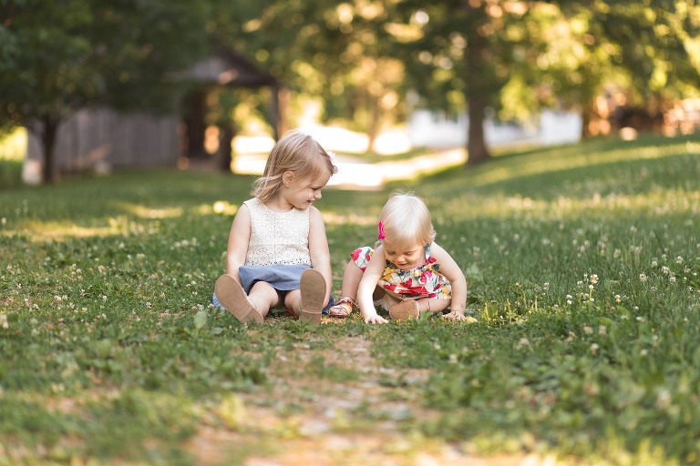 Sisters sitting in the grass in Faust Park | St. Louis Children's Photographer