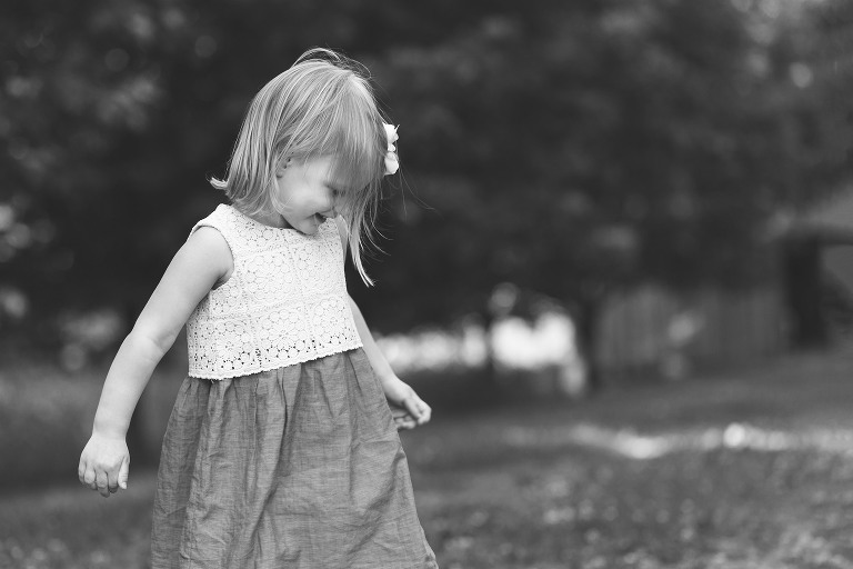 Little girl twirling in her dress in Faust Park | St. Louis Photographer