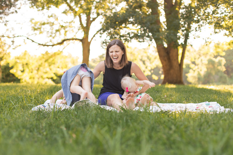 Mommy laughing at one of her daughters in Faust Park | St. Louis Family Photographer