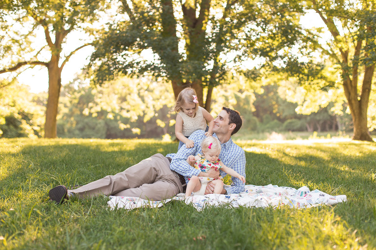 Daddy and his two little girls playing on blanket in Faust Park | St. Louis Photographer