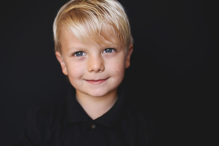 Blonde haired young boy smiling at camera | St. Louis School Photography