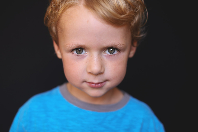 Young boy wearing blue shirt looking at camera | St. Louis School Photos