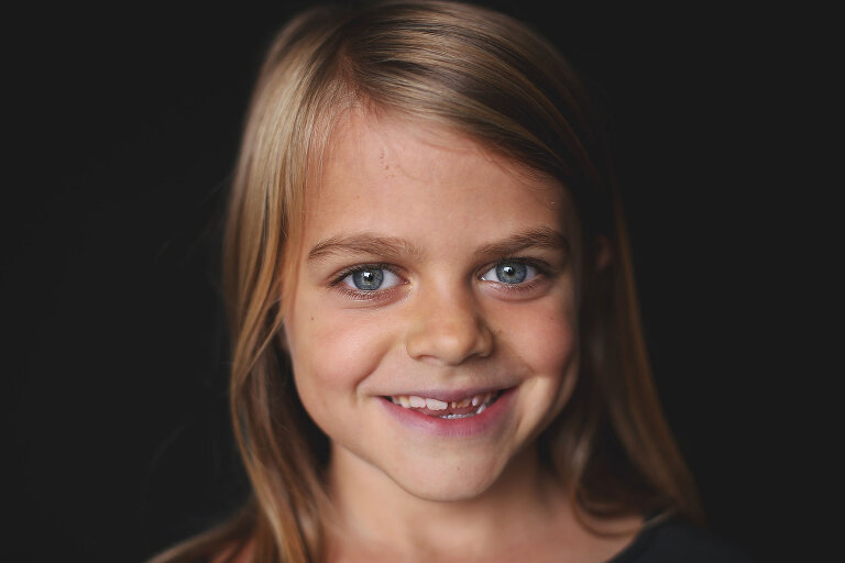 Girl with beautiful eyes smiling while looking at camera | St. Louis School Photos