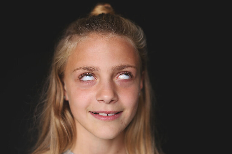 Pre teen girl rolling her eyes at camera | St. Louis School Photos