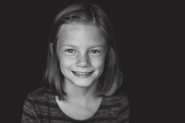 Sweet young girl smiling at camera | St. Louis School Photographer