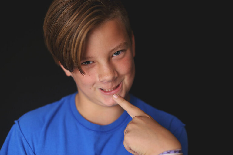 Boy being silly while having photograph taken | St. Louis School Photos