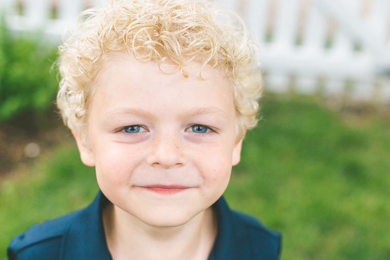 Little blonde haired boy smiling at camera | St. Louis Family Photos