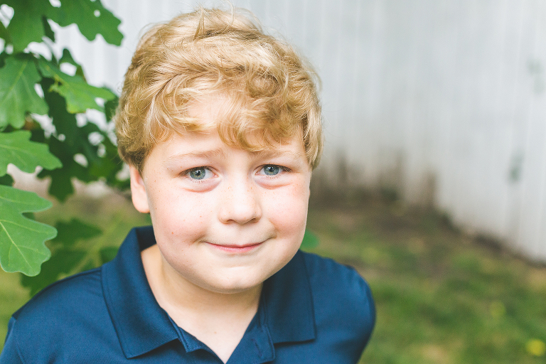 Older boy with blonde hair giving camera a slight smile. | St. Louis Family Photos