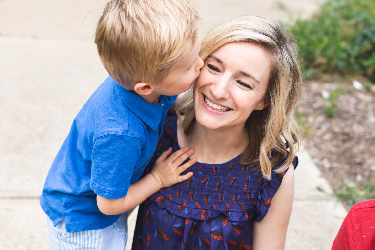 Young boy giving his mom a kiss on her cheek in Francis Park | Family Photography St. Louis