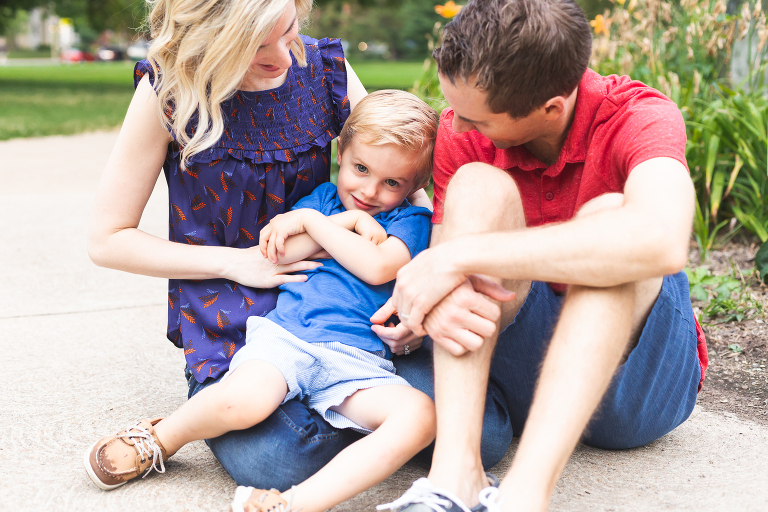 Family of 3 sitting on sidewalk in Francis Park | St. Louis Photographer