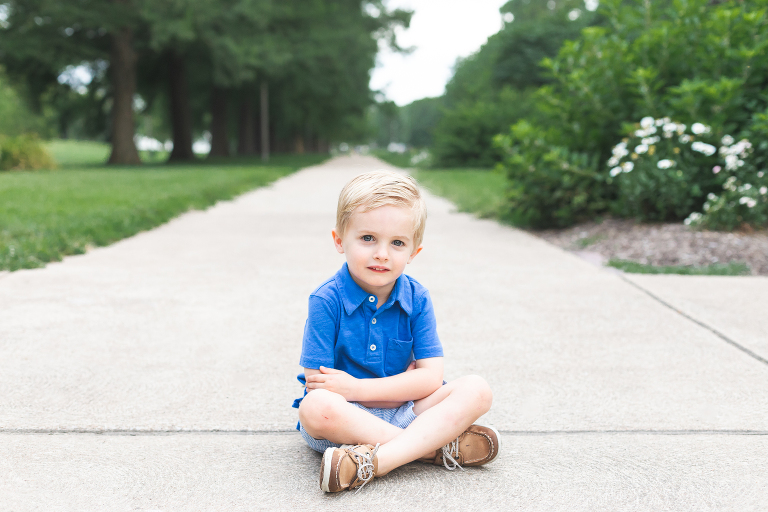 Sweet little guy sitting on sidewalk in Francis Park | Family Photography St. Louis