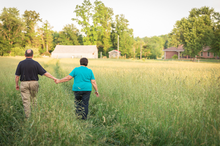 Husband and wife walking together on their farm | St. Louis Family Photography