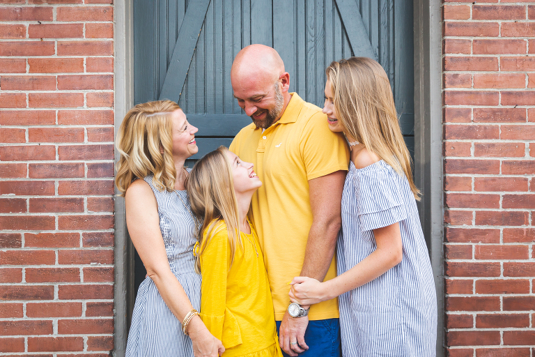 Family of 4 having fun exploring downtown | St. Charles Family Photographer