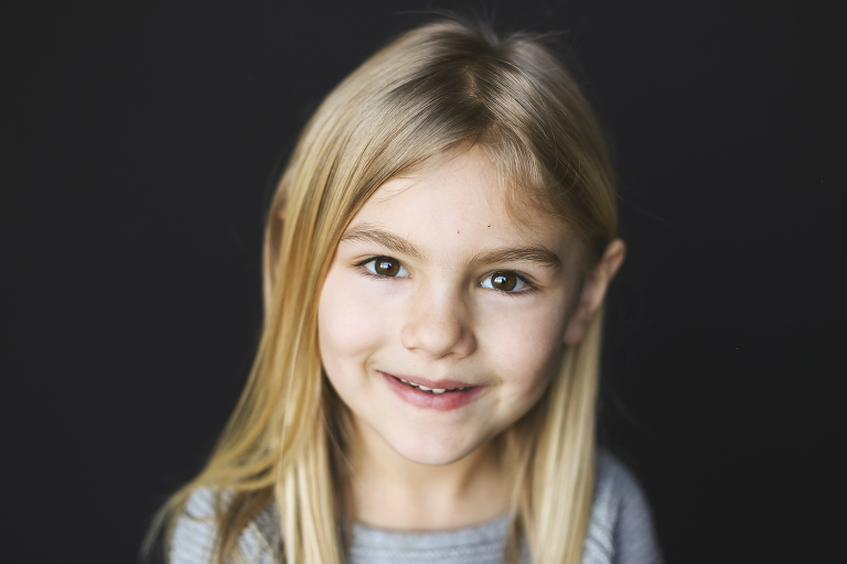 Young girl looking at camera for school photo | St. Louis School Photos