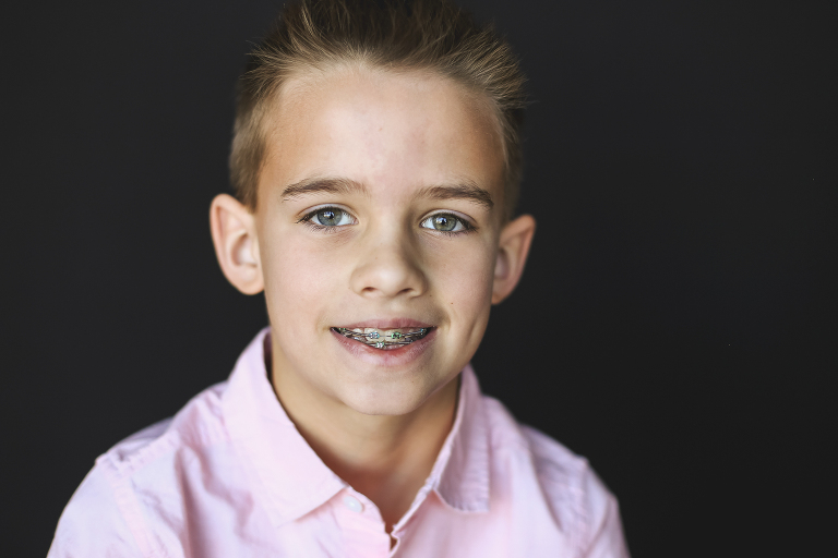 Young boy with braces looking at camera | St. Louis School Photographer